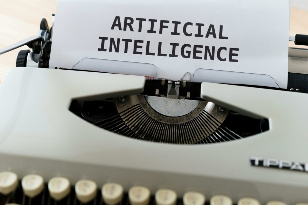 Numérique A close-up of a typewriter showcasing 'ARTIFICIAL INTELLIGENCE' on paper.